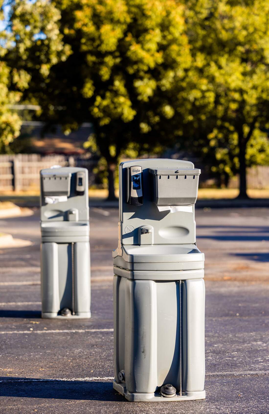 Freestanding hand sanitizer stations positioned outdoors at a Newport Beach event